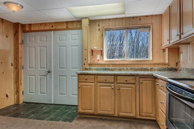 kitchen featuring wooden walls, a paneled ceiling, and electric stove