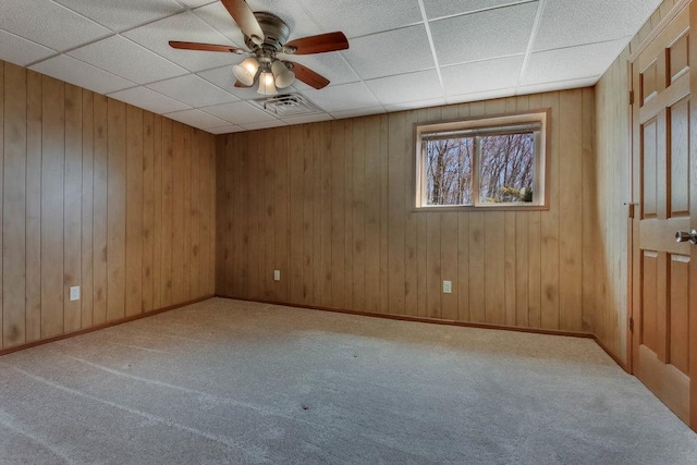 unfurnished room featuring carpet floors, ceiling fan, visible vents, and a paneled ceiling