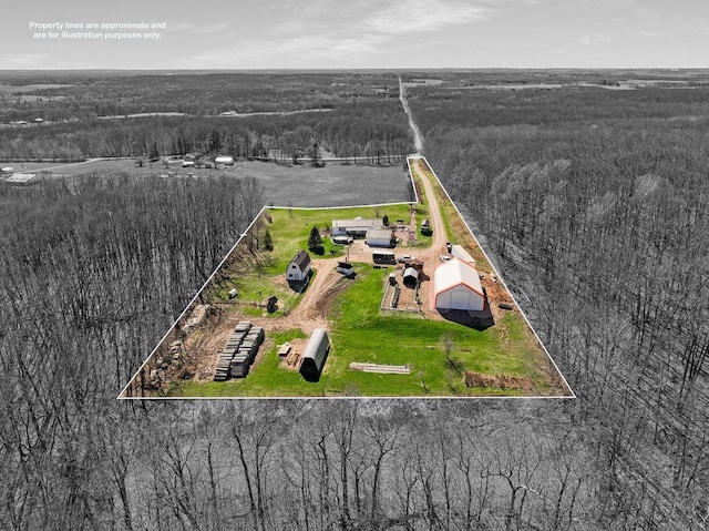 birds eye view of property with a view of trees
