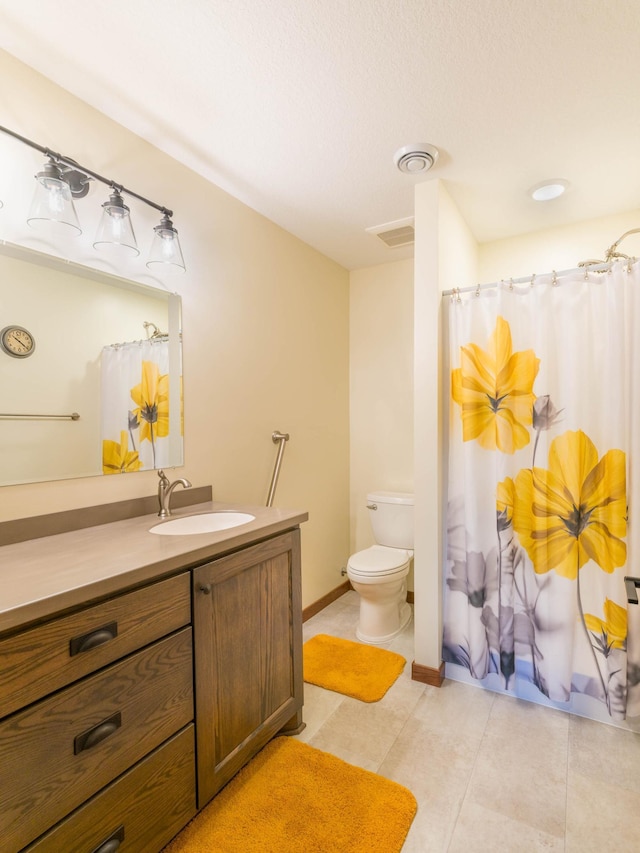 bathroom with vanity, toilet, tile patterned floors, and a shower with shower curtain