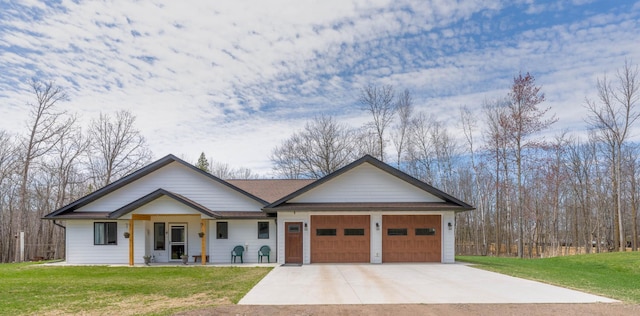 view of front of home with concrete driveway, an attached garage, a front lawn, and a shingled roof