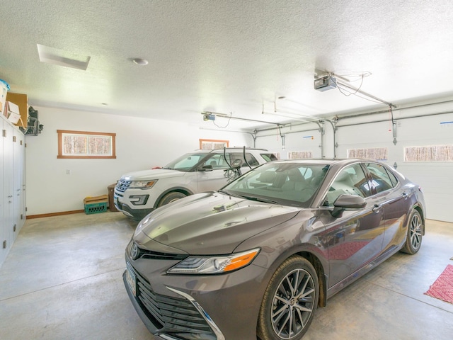 garage featuring a garage door opener and baseboards