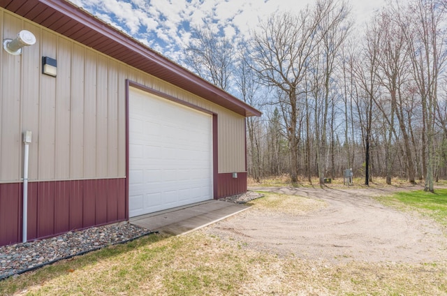 garage with dirt driveway