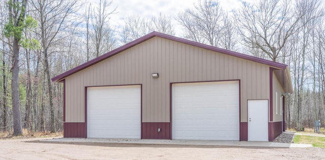 detached garage featuring a forest view