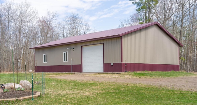 view of outbuilding with dirt driveway and an outbuilding
