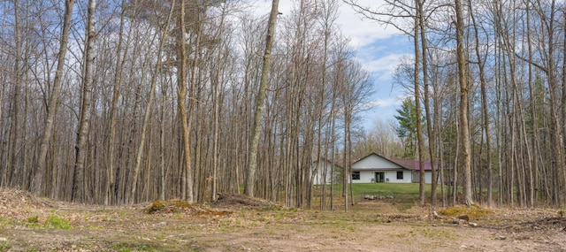 view of yard with a view of trees