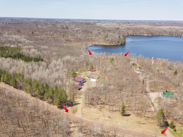 bird's eye view of a nearby body of water and a heavily wooded area
