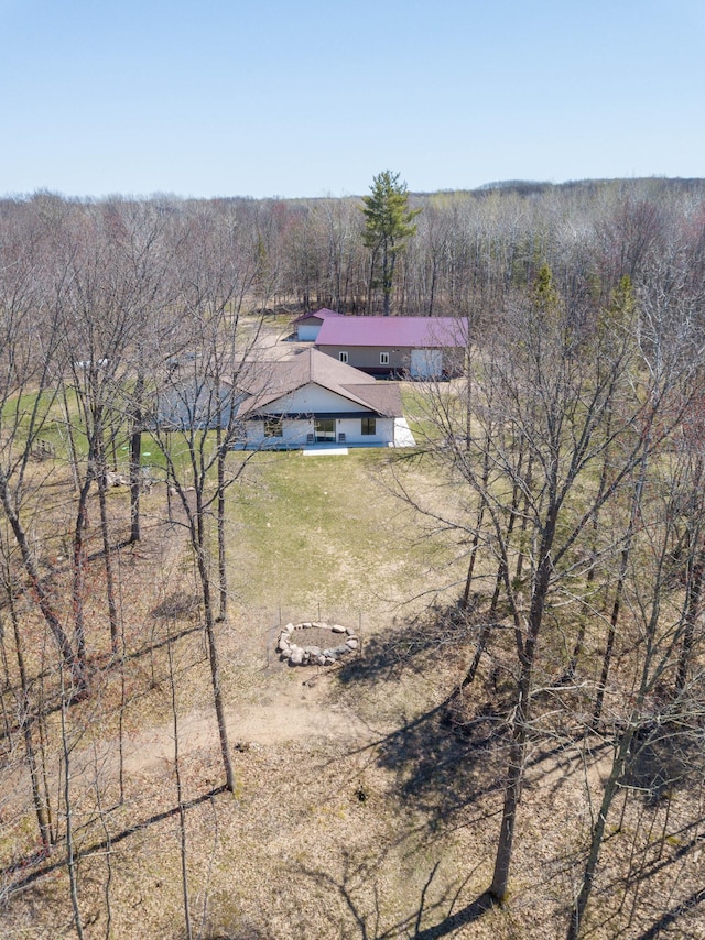 view of subject property featuring a forest