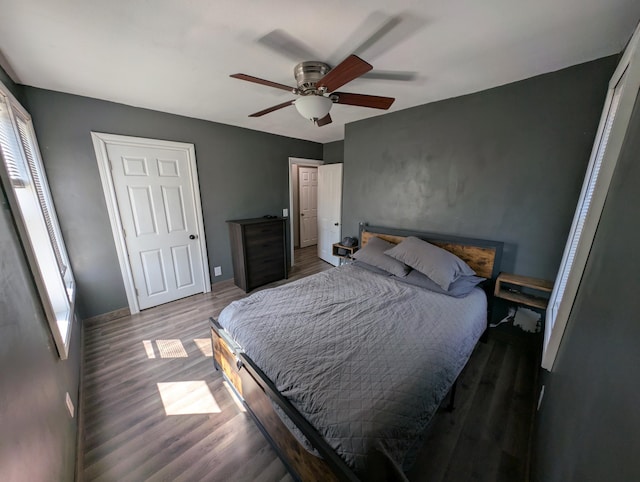 bedroom with wood finished floors, ceiling fan, and baseboards