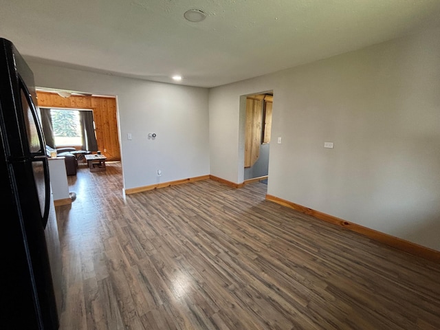 unfurnished room featuring wood finished floors, baseboards, and recessed lighting