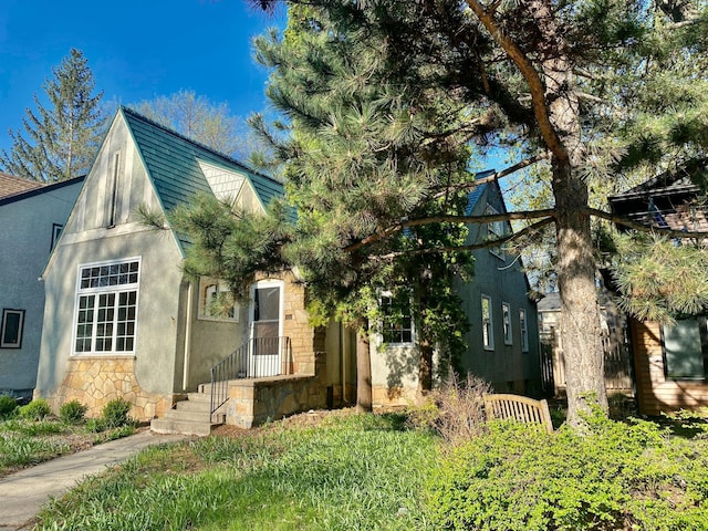 view of front of house with stucco siding and stone siding