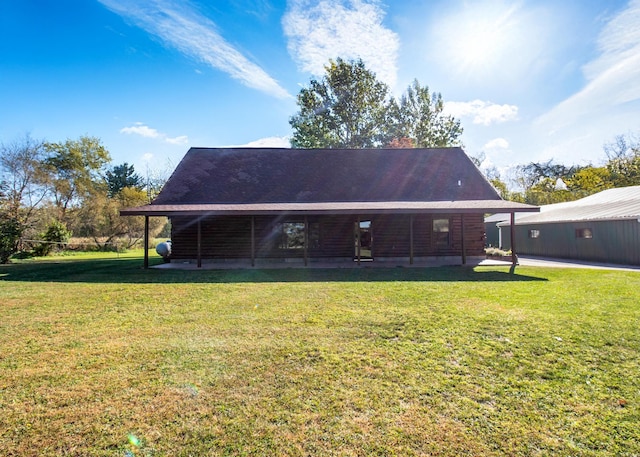 rear view of house featuring a chimney and a lawn