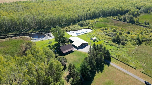 aerial view featuring a wooded view and a water view