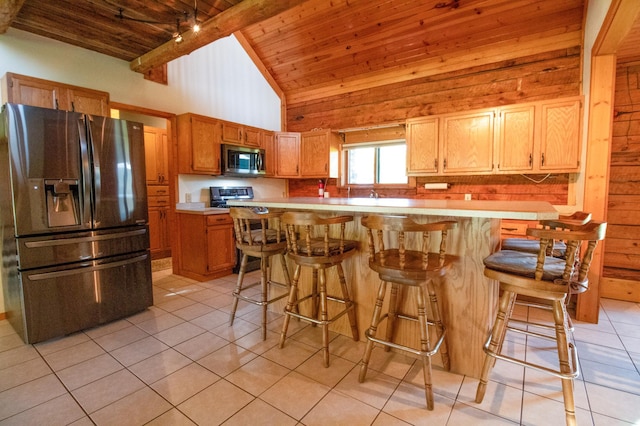 kitchen featuring wooden ceiling, light tile patterned flooring, high vaulted ceiling, light countertops, and appliances with stainless steel finishes