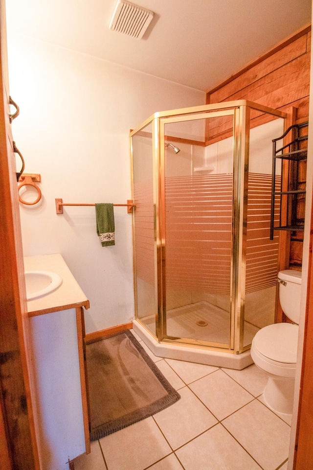 full bath with a shower stall, tile patterned flooring, and visible vents
