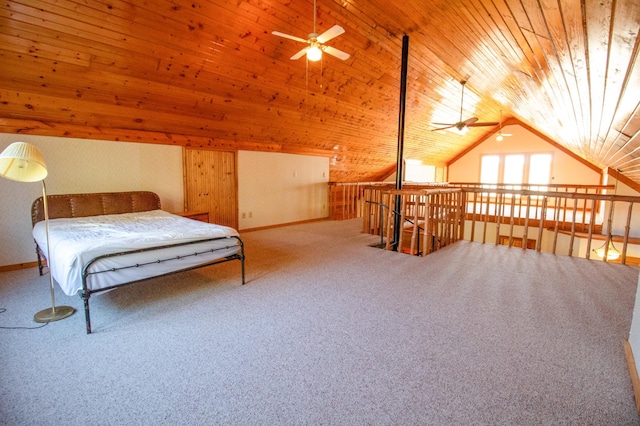 carpeted bedroom featuring baseboards, wood ceiling, and vaulted ceiling