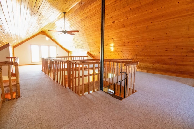 bonus room with carpet flooring, a ceiling fan, wood walls, wooden ceiling, and vaulted ceiling