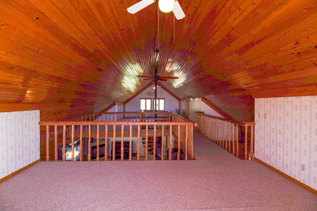 bonus room featuring a ceiling fan, carpet floors, wallpapered walls, and wood ceiling