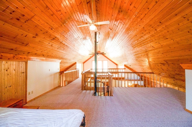 bedroom featuring carpet, lofted ceiling, wood walls, and wooden ceiling