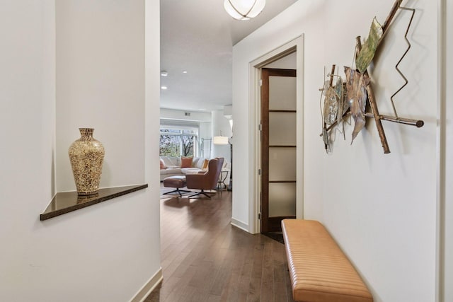 hallway with baseboards, recessed lighting, and dark wood-style flooring