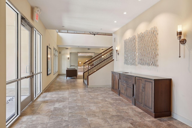 hall featuring recessed lighting, baseboards, and stairs