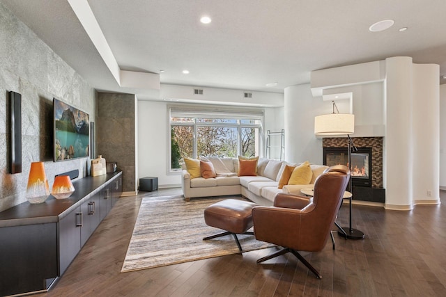 living room featuring dark wood finished floors, a tiled fireplace, recessed lighting, baseboards, and visible vents