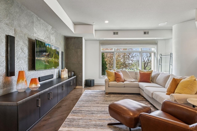 living room featuring visible vents, recessed lighting, dark wood finished floors, and baseboards