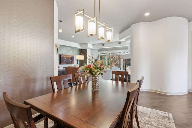 dining space with recessed lighting, baseboards, and wood finished floors