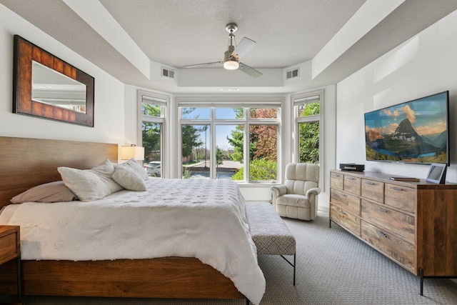 carpeted bedroom featuring ceiling fan and visible vents