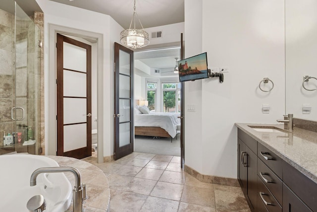ensuite bathroom featuring visible vents, an inviting chandelier, baseboards, connected bathroom, and a shower stall