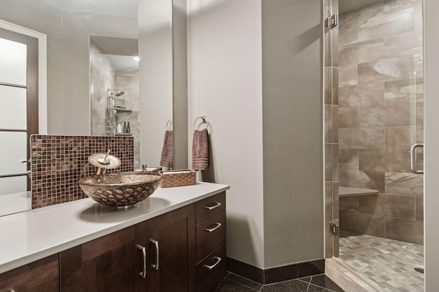 bathroom with vanity, backsplash, and a stall shower
