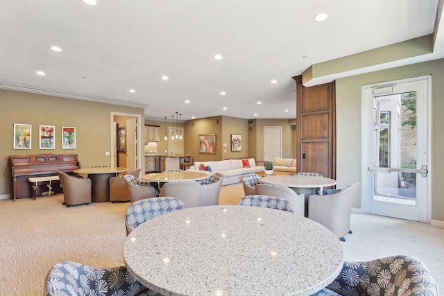 dining room featuring recessed lighting and light colored carpet