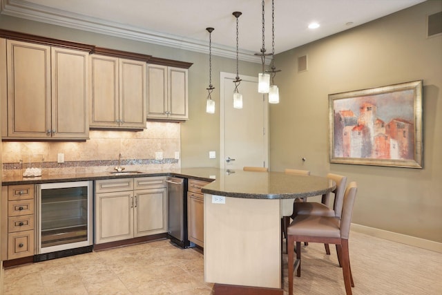 kitchen featuring a peninsula, wine cooler, a kitchen breakfast bar, tasteful backsplash, and a sink