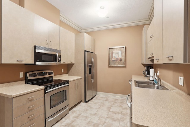 kitchen with a sink, light countertops, ornamental molding, and stainless steel appliances