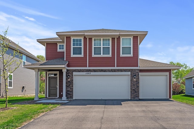 11263 131st Cir N, Dayton, MN 55327 - view of front of property with asphalt driveway, stone siding, roof with shingles, and a garage