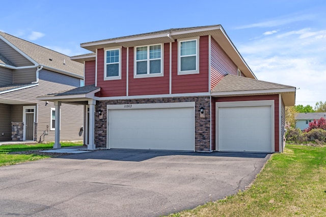 11263 131st Cir N, Dayton, MN 55327 - view of front of house featuring asphalt driveway, a garage, a shingled roof, and stone siding