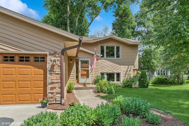 17150 Grenadier Ave, Lakeville, MN 55044 - view of front of house featuring stone siding, an attached garage, a front lawn, and driveway