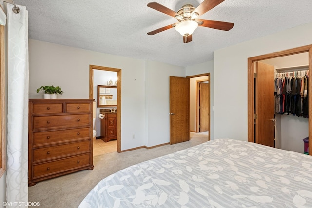 17150 Grenadier Ave, Lakeville, MN 55044 - bedroom featuring light colored carpet, a walk in closet, a closet, a textured ceiling, and connected bathroom
