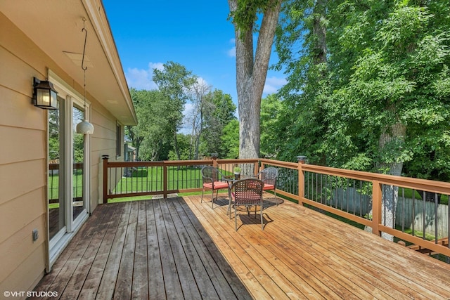 17150 Grenadier Ave, Lakeville, MN 55044 - wooden deck with outdoor dining space and view of wooded area