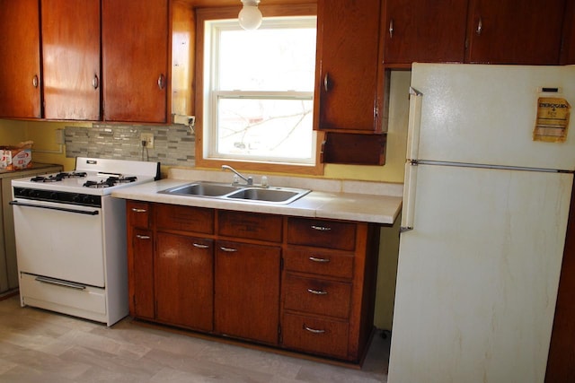 712 Kendall Ave S, Thief River Falls, MN 56701 - kitchen with white appliances, light countertops, decorative backsplash, and a sink
