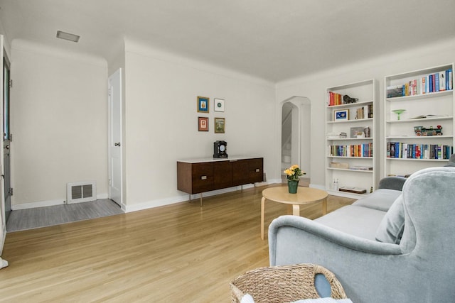 1677 Niles Ave, Saint Paul, MN 55116 - living room featuring arched walkways, light wood finished floors, and built in features