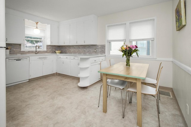 1677 Niles Ave, Saint Paul, MN 55116 - kitchen with dishwasher, light countertops, plenty of natural light, and white cabinets