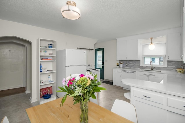 1677 Niles Ave, Saint Paul, MN 55116 - kitchen featuring white appliances, light countertops, white cabinets, decorative backsplash, and a textured ceiling