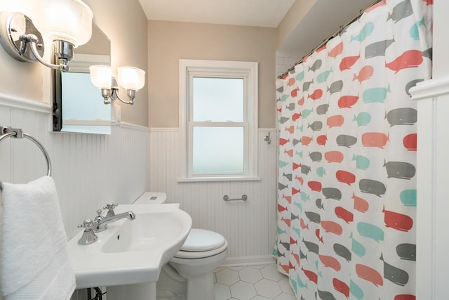 1677 Niles Ave, Saint Paul, MN 55116 - bathroom with wainscoting, tile patterned floors, and curtained shower