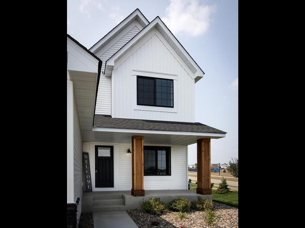 modern inspired farmhouse featuring a porch, a shingled roof, and board and batten siding