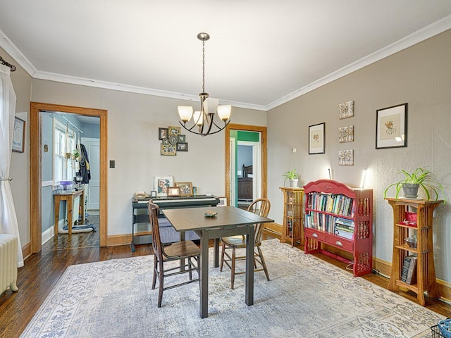 2100 Saint Clair Ave, Saint Paul, MN 55105 - dining room featuring a chandelier, crown molding, wood finished floors, and baseboards
