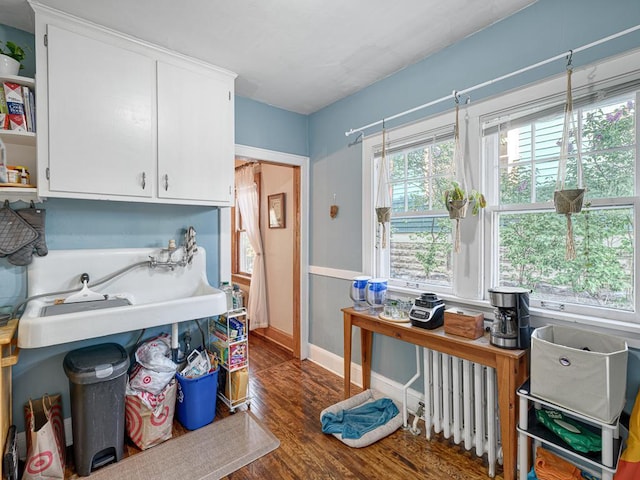 2100 Saint Clair Ave, Saint Paul, MN 55105 - kitchen featuring white cabinets, open shelves, wood finished floors, baseboards, and radiator