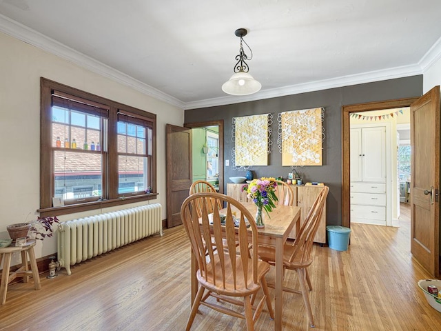 2100 Saint Clair Ave, Saint Paul, MN 55105 - dining area with radiator, light wood-type flooring, and ornamental molding