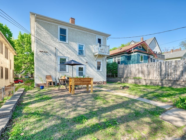 2100 Saint Clair Ave, Saint Paul, MN 55105 - back of house featuring a balcony, a chimney, and stucco siding