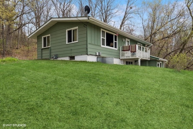 904 Washington St, Saint Croix Falls, WI 54024 - back of house featuring a lawn, board and batten siding, and a balcony
